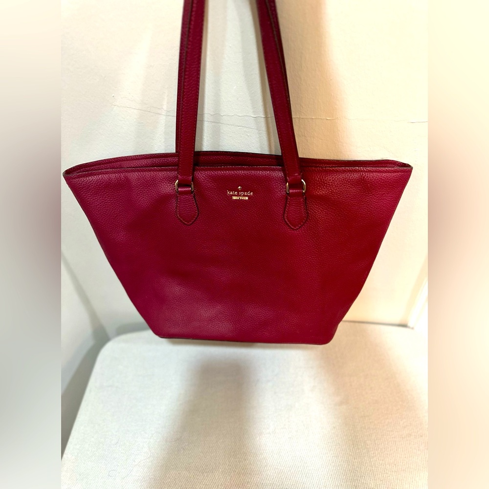 Beautiful burgundy large Kate spade tote bag with black and white interior.